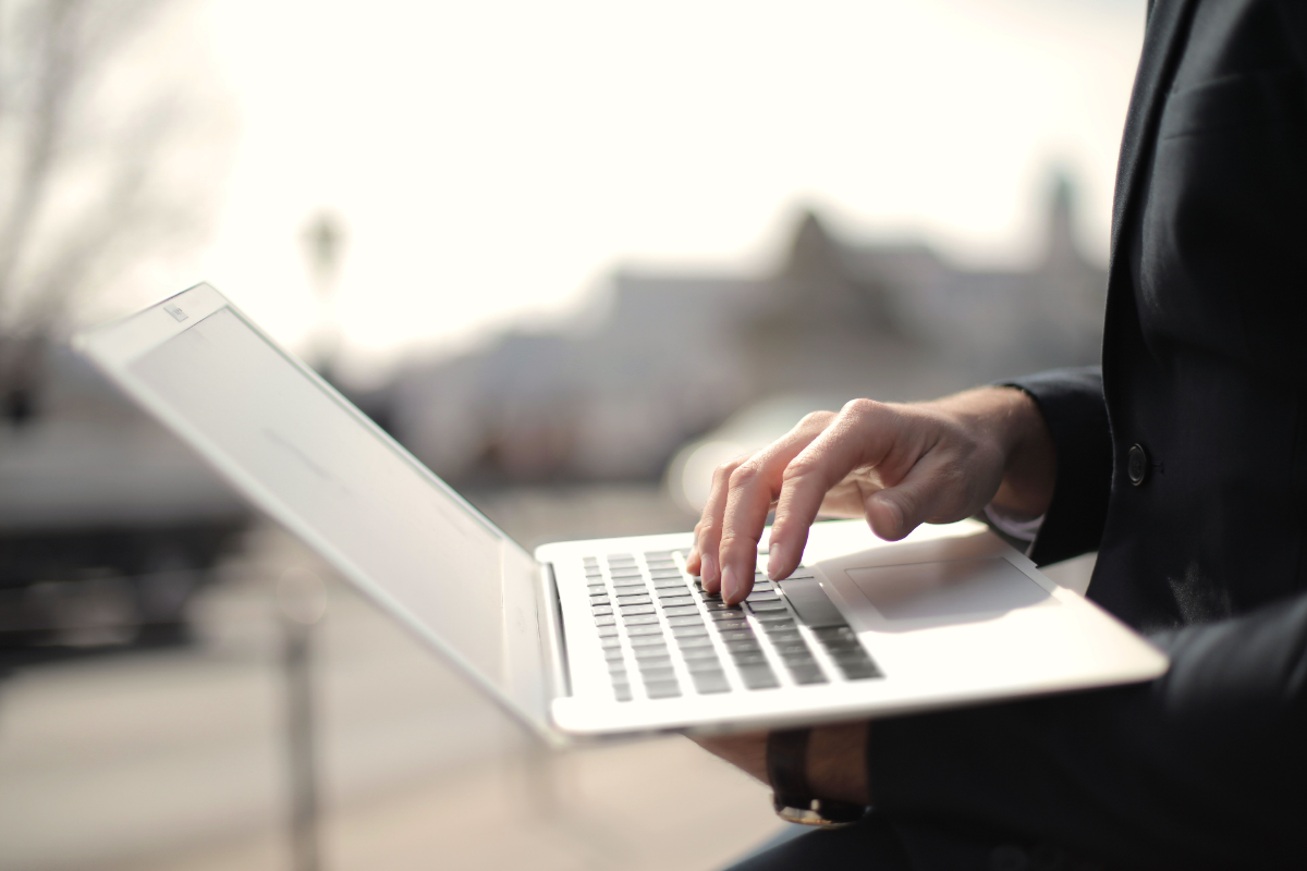 A person browsing the web on a laptop in a public space
